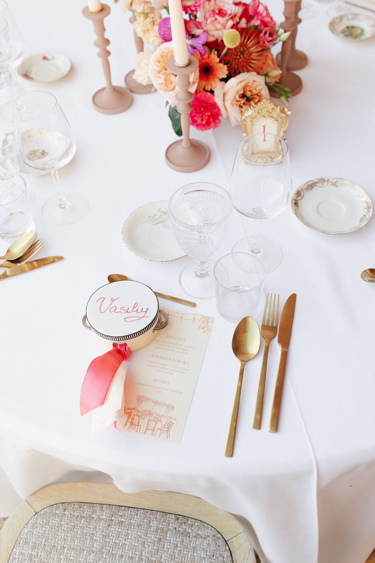 Place setting with a guest's name tag and gold cutlery