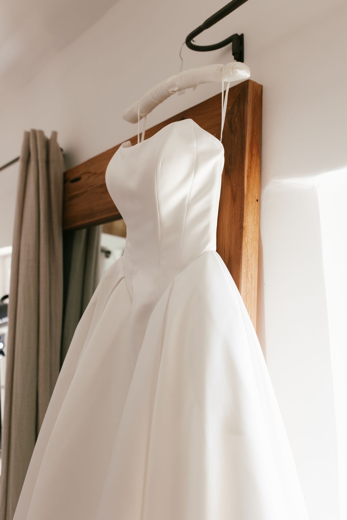 Bride's wedding gown hanging before the ceremony