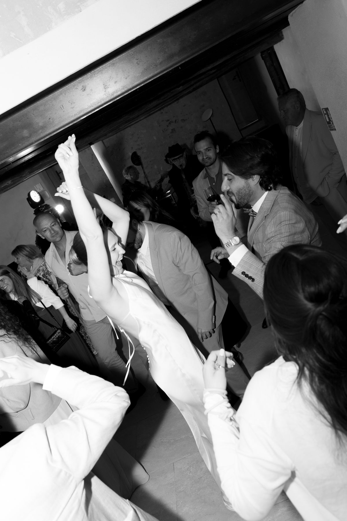 Guests dancing at the reception, black and white