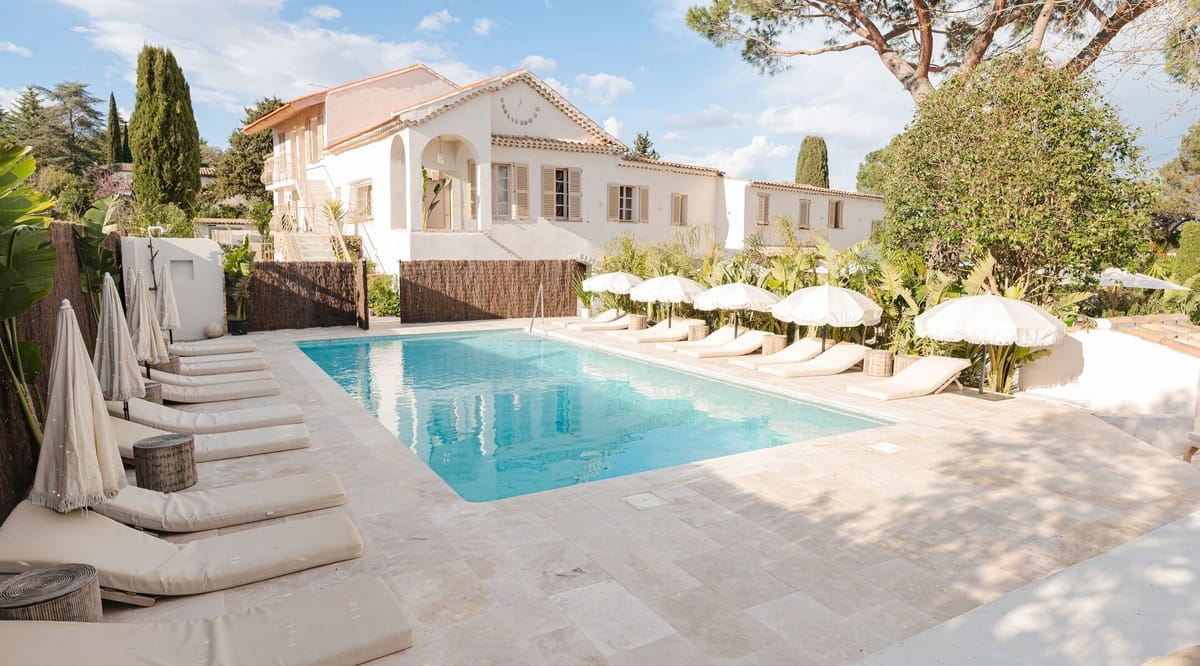 The hotel and swimming pool seen across the garden