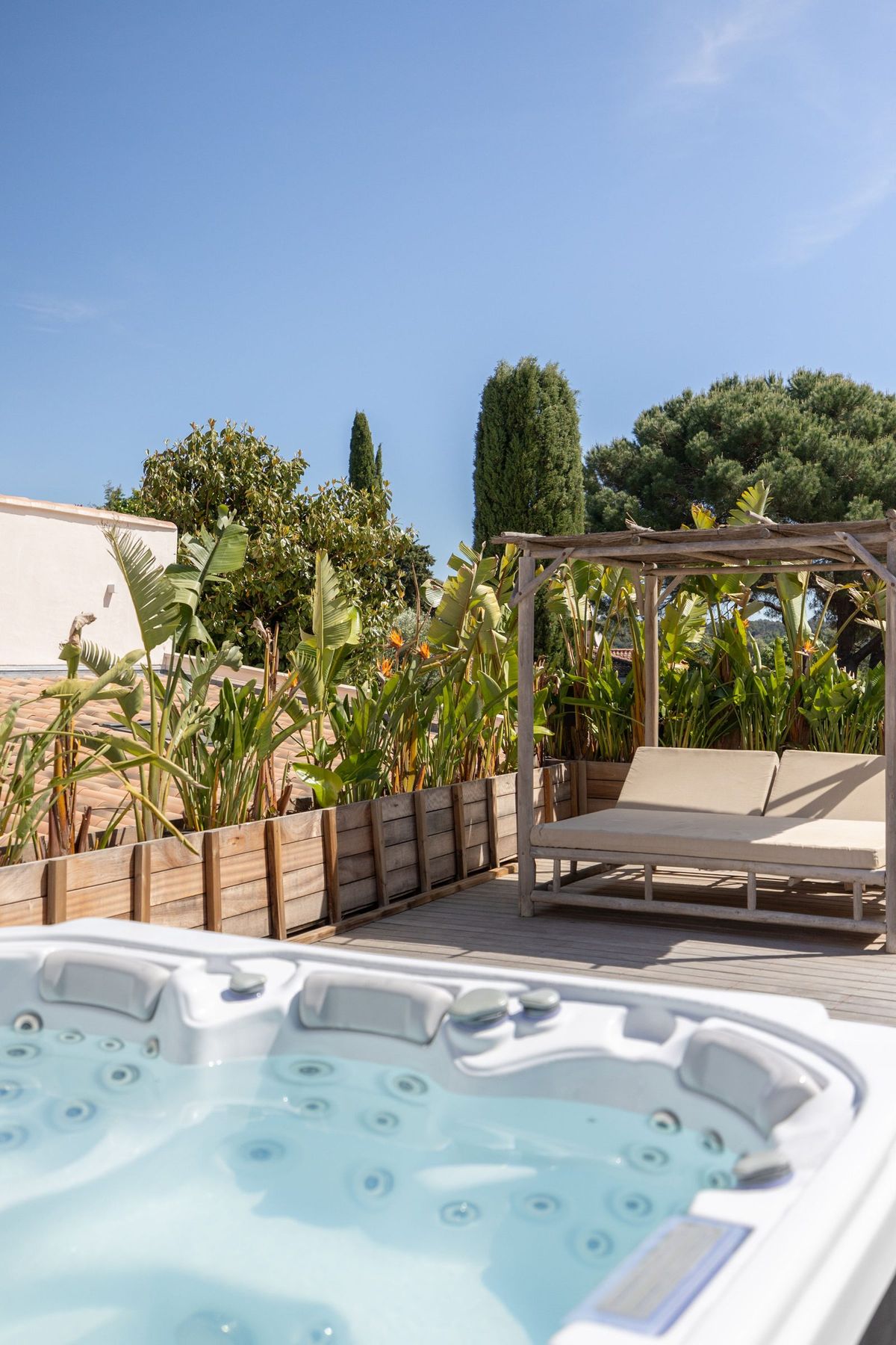 An outdoor jacuzzi set among the planting