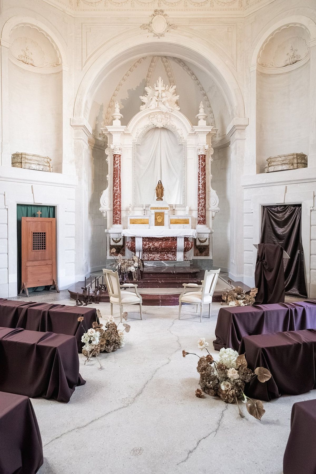 Château du Terral chapel set for a ceremony with marble altar, Madonna statue and draped seating