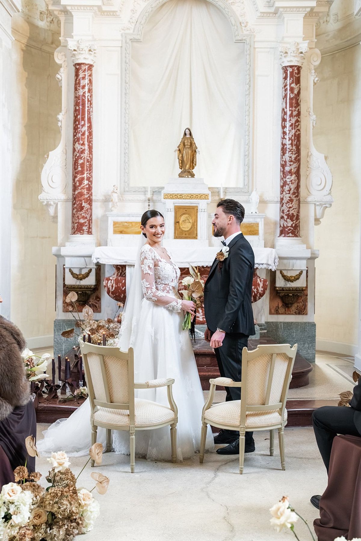 Bride and groom exchange vows at the marble altar of Château du Terral's chapel
