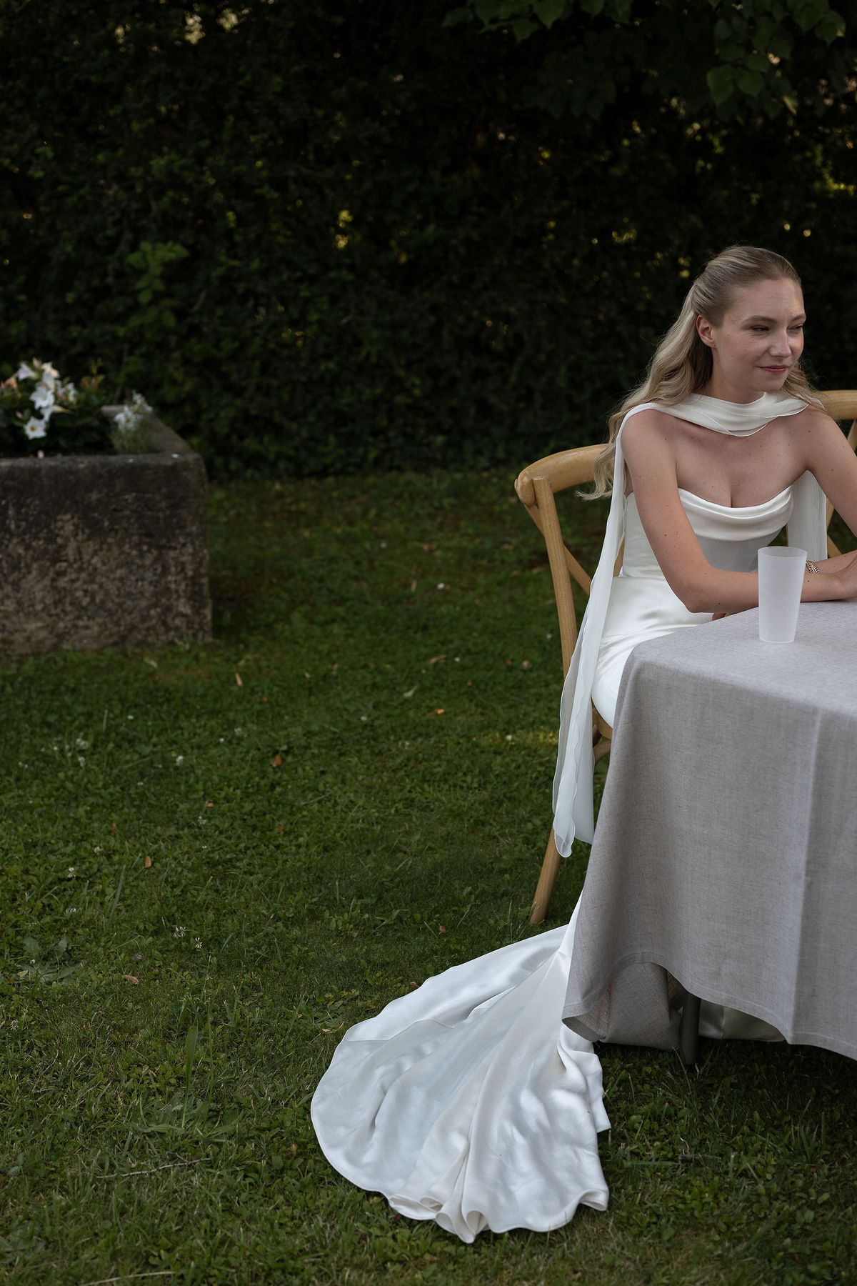 Louise seated at a draped table in the garden of her family home in the Luberon