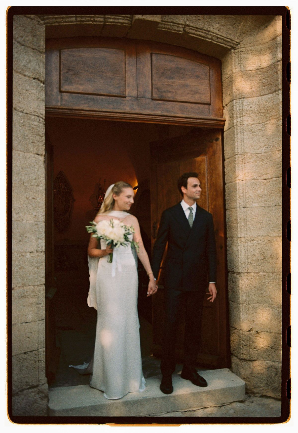 Louise and Lucas in the doorway of the village church, photographed on film
