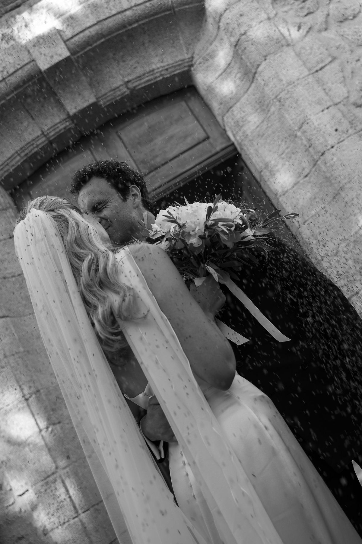 Black and white photograph of Louise and Lucas embracing after their ceremony