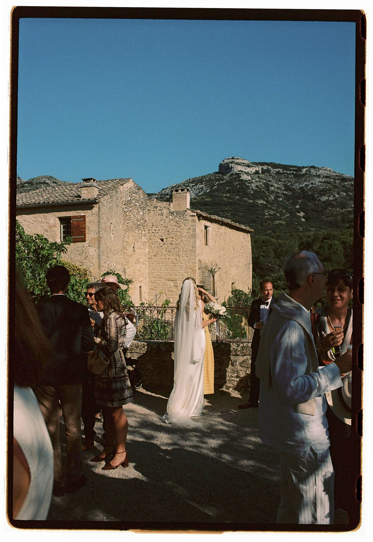 Louise and Lucas leaving the church into the village square, photographed on film