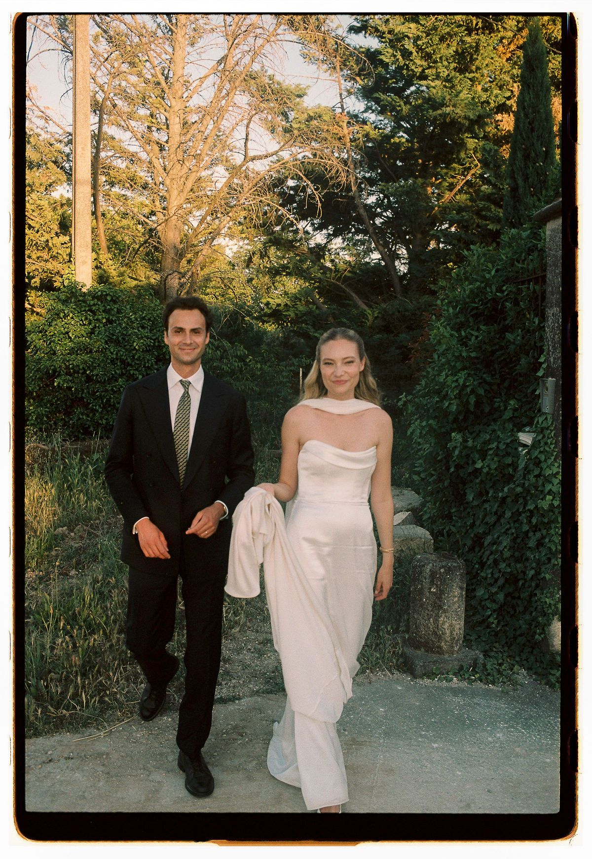 Louise and Lucas walking together at their Luberon wedding, photographed on film