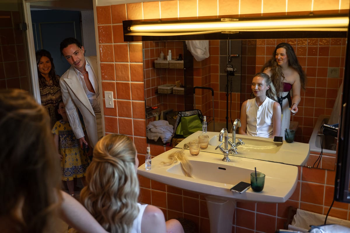 Louise having her hair styled with family around her before her spring wedding in Provence