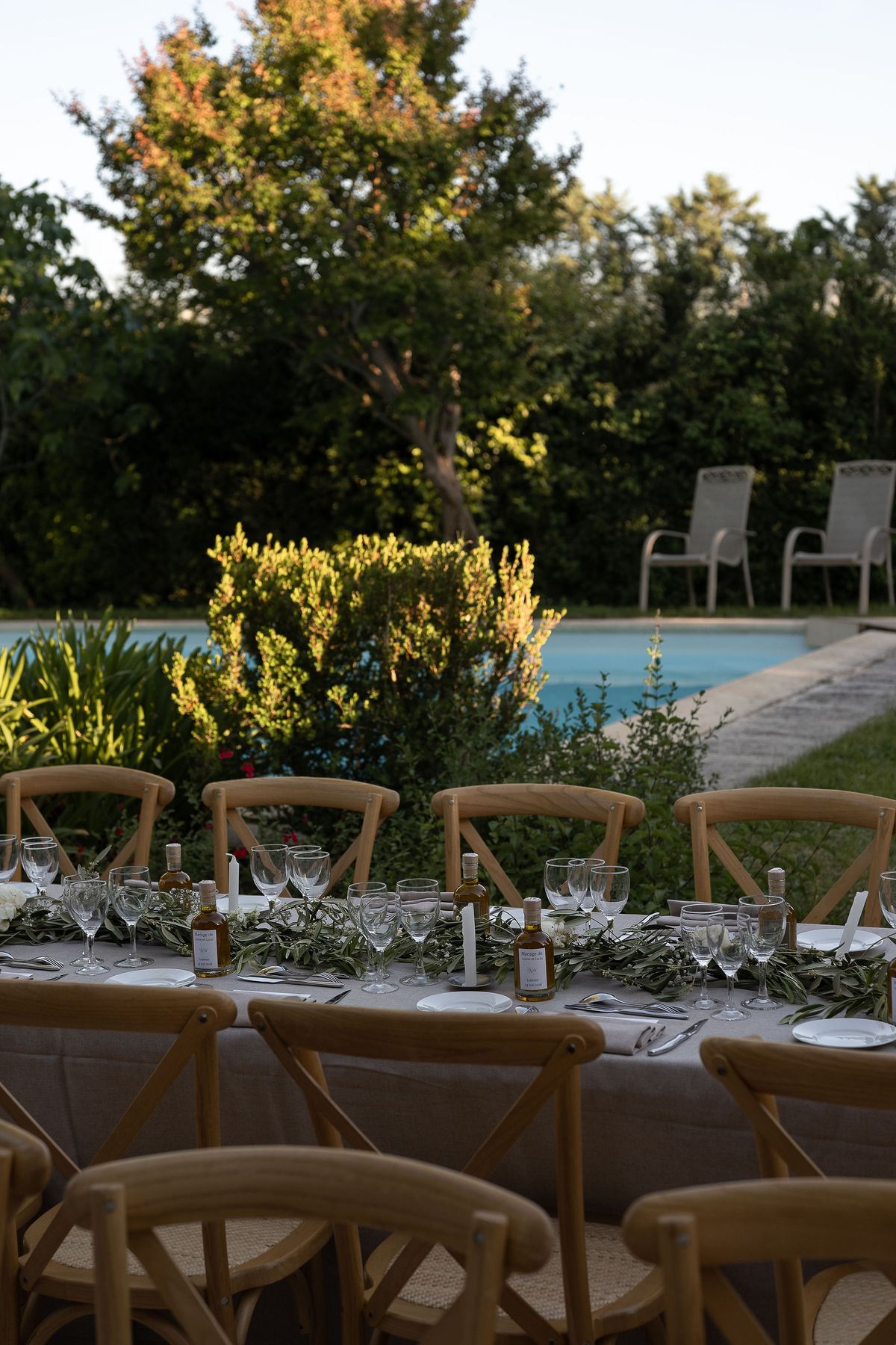 Reception tables set in the garden with the swimming pool beyond