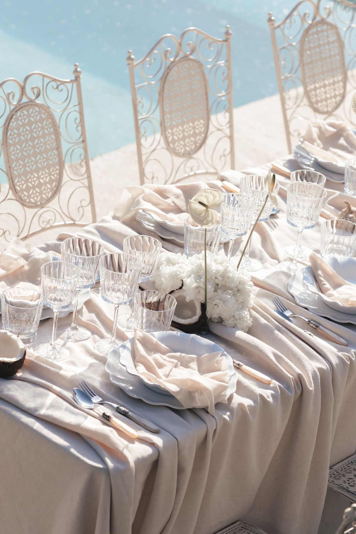 Tablescape detail with cut crystal glassware, ivory linen napkins and white florals at Couvent Notre-Dame des Prés