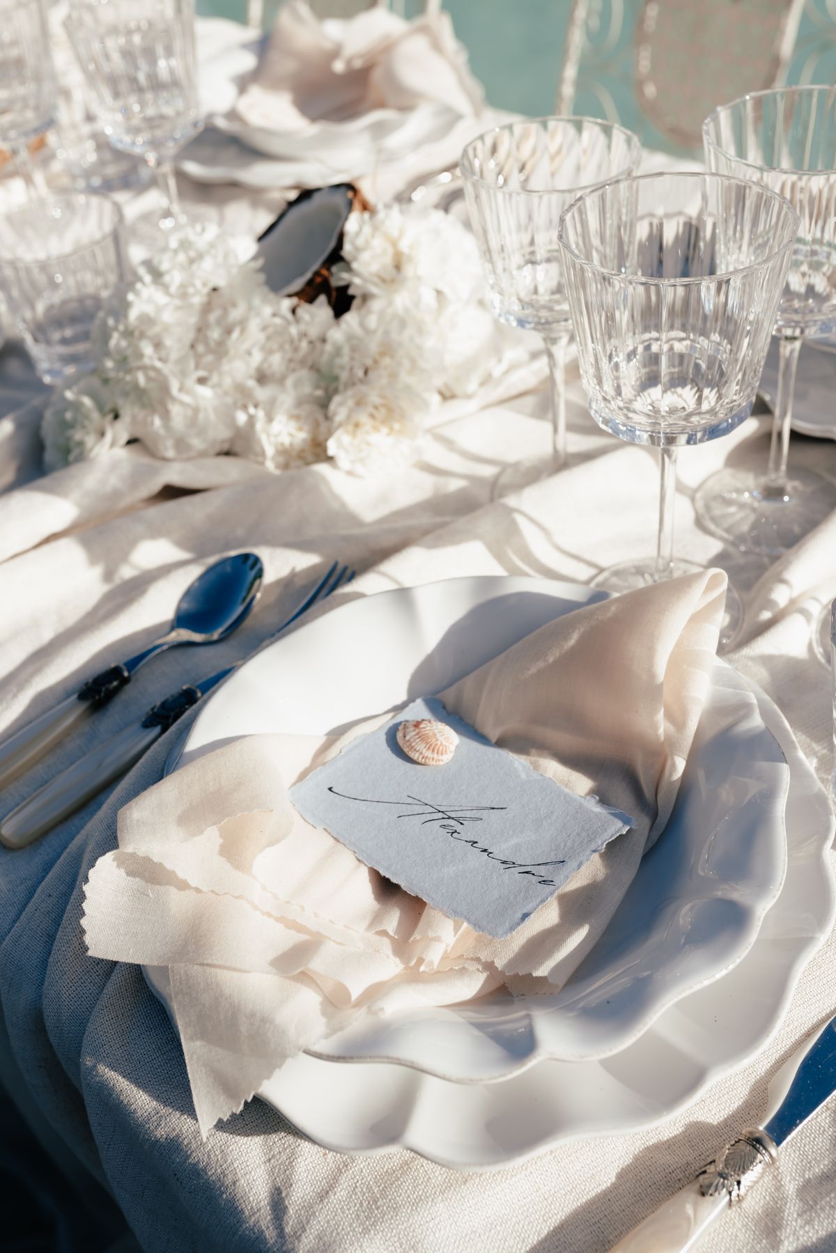 Place setting with a handwritten thank you card on textured paper