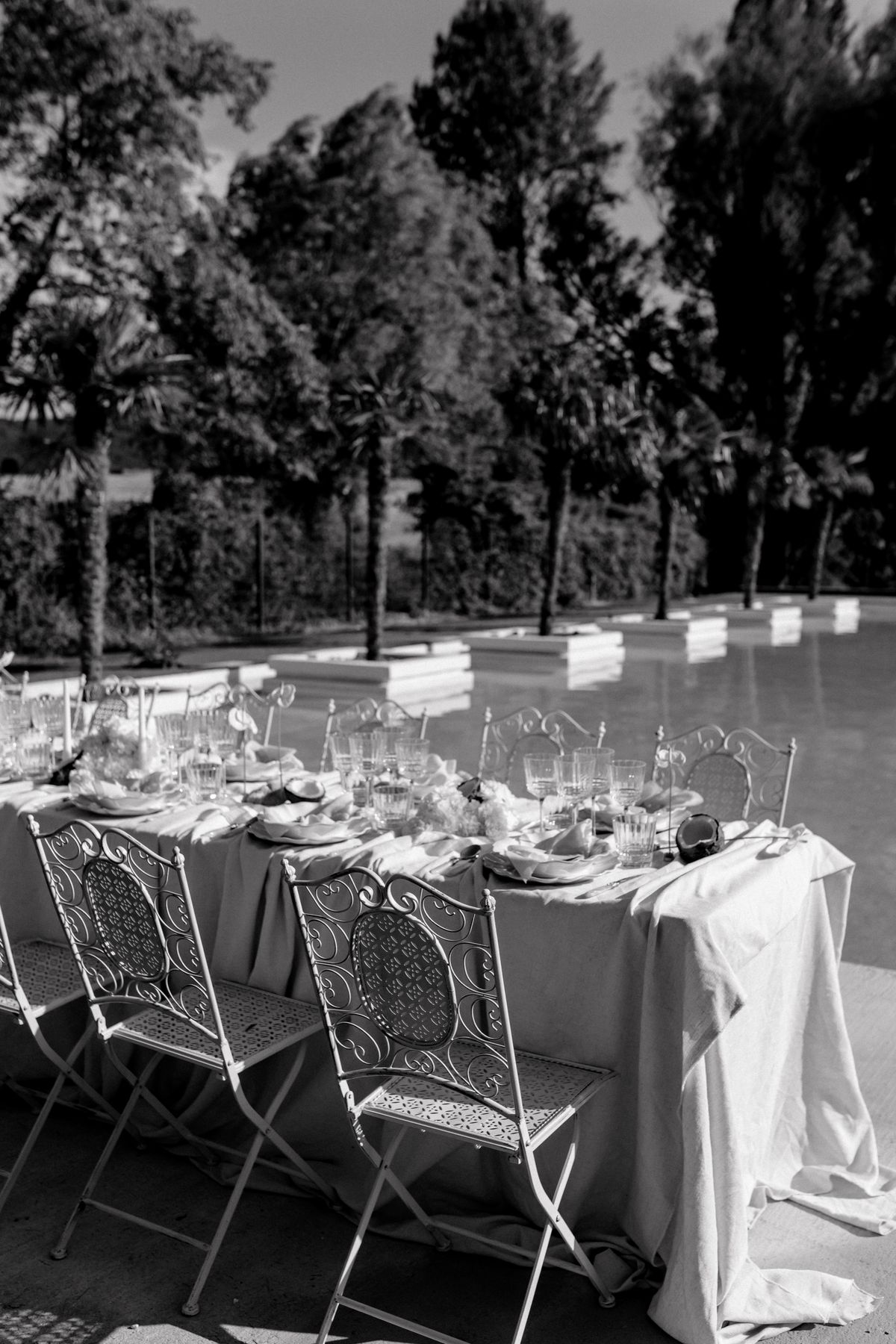 Black and white view along the reception table and wrought iron chairs