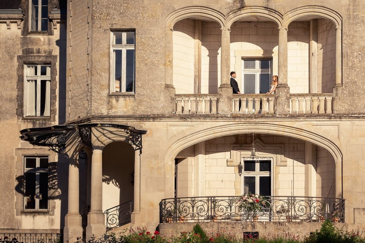 Blush and fuchsia styled shoot at Château du Causse, Occitanie, the arched balconies of the château façade
