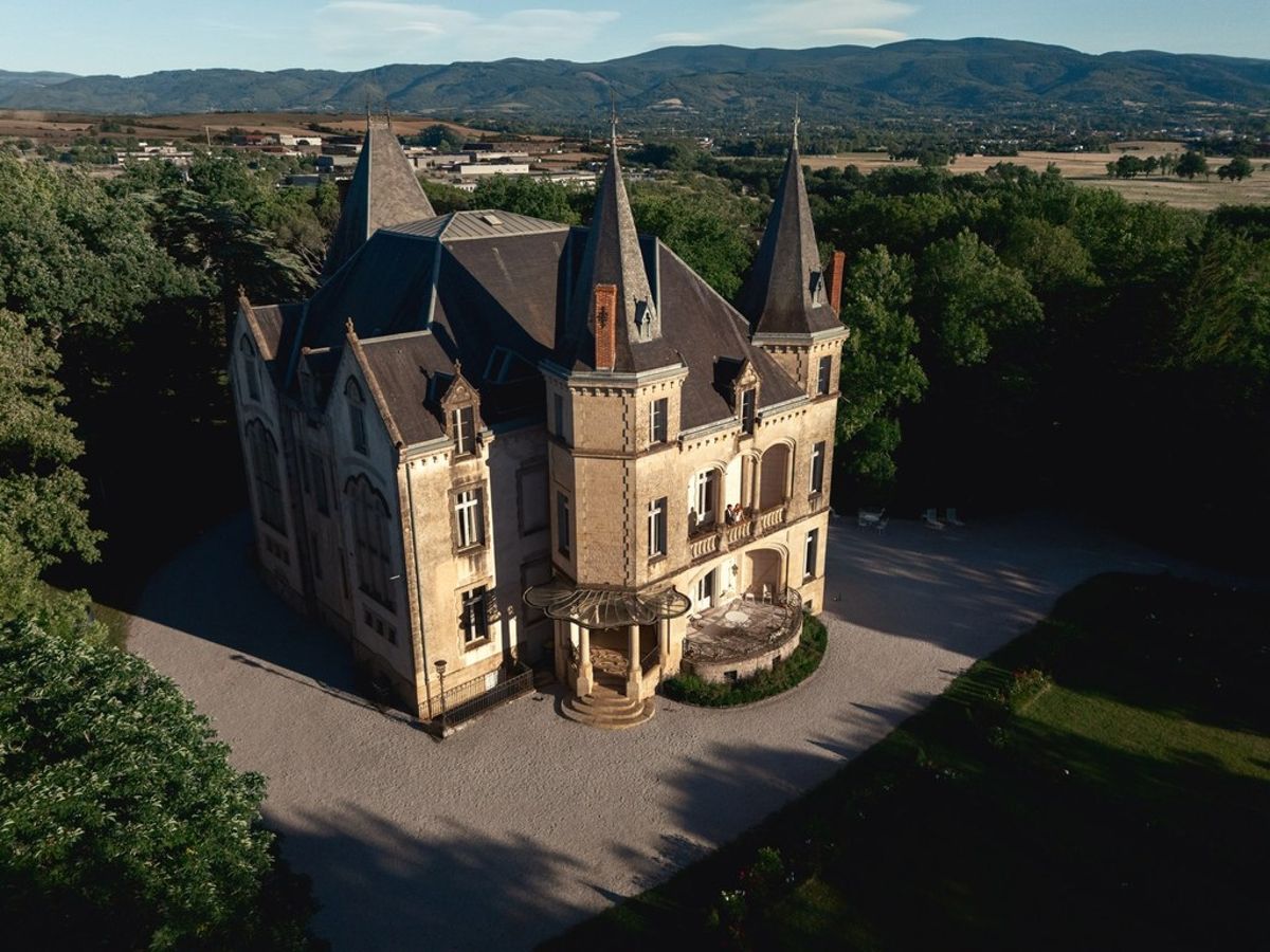 Blush and fuchsia styled shoot at Château du Causse, Occitanie, an aerial view of Château du Causse and its park