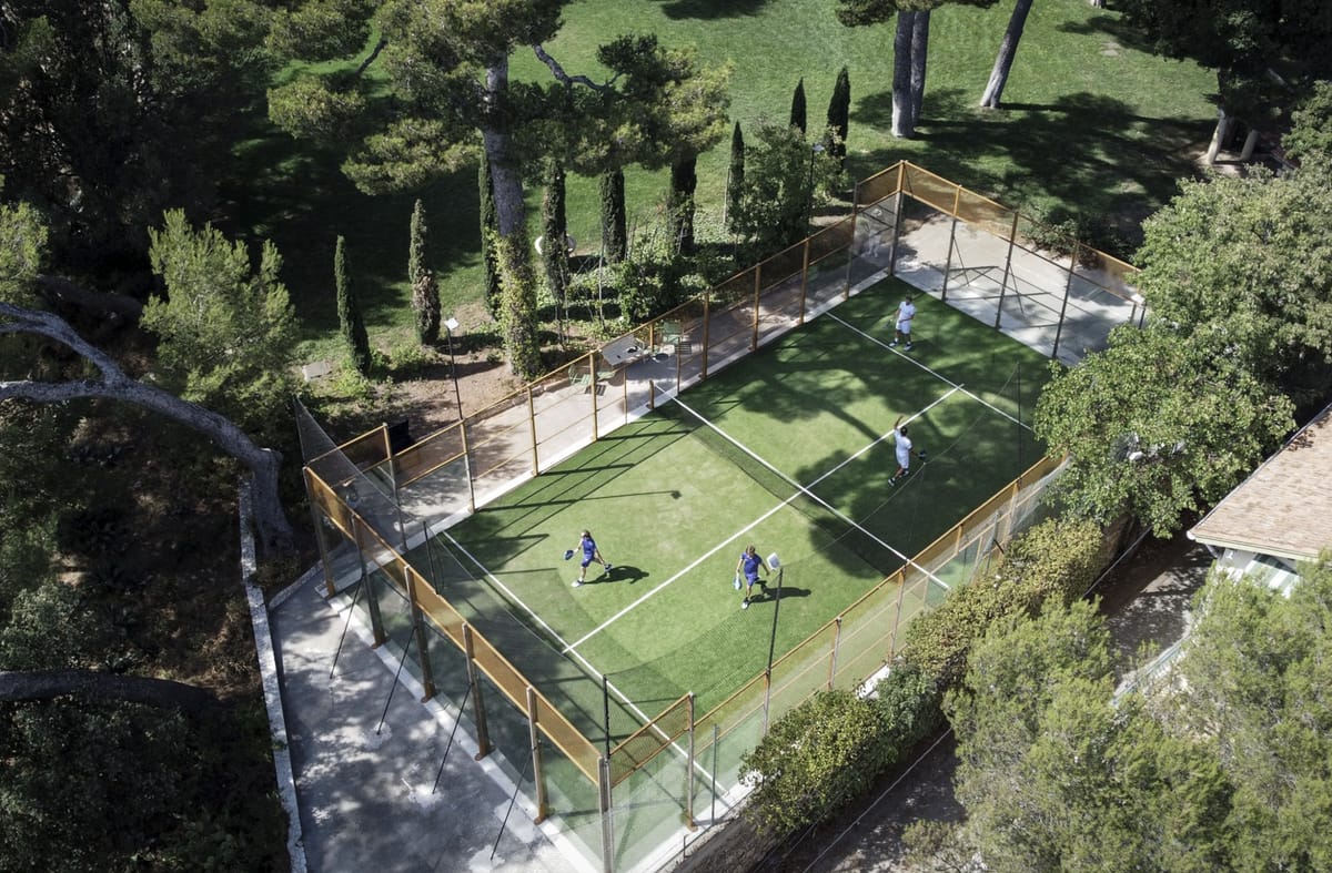 Aerial view of the padel court among pine trees at Domaine Rocabella, French Riviera