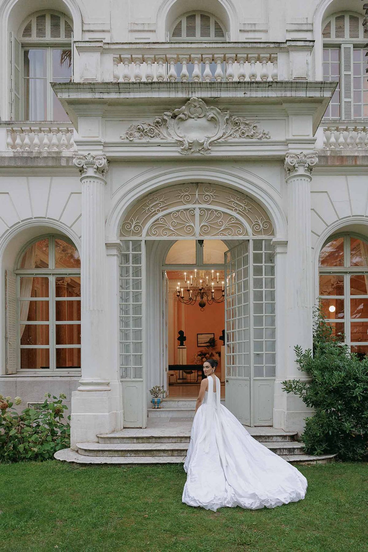 Bride at the entrance steps of the Belle Epoque villa at Domaine Rocabella, French Riviera