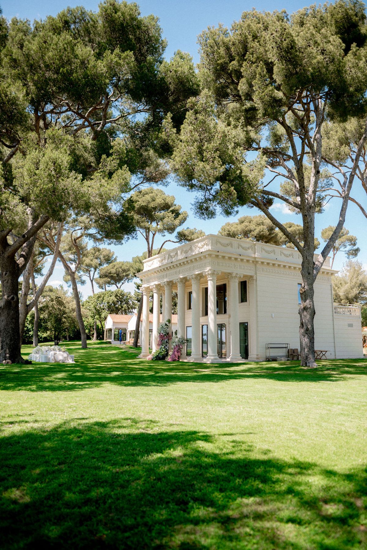 Colonnaded pavilion on the lawn among pine trees at Domaine Rocabella, French Riviera
