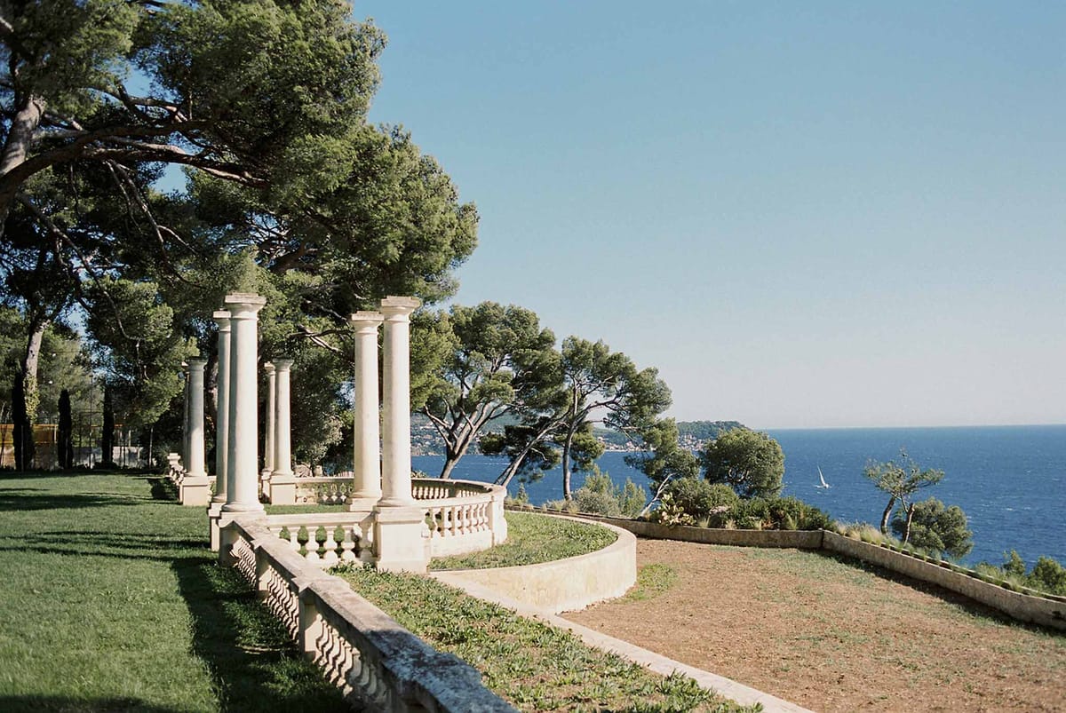 Stone colonnade and balustrade on the lawn above the sea at Domaine Rocabella, French Riviera