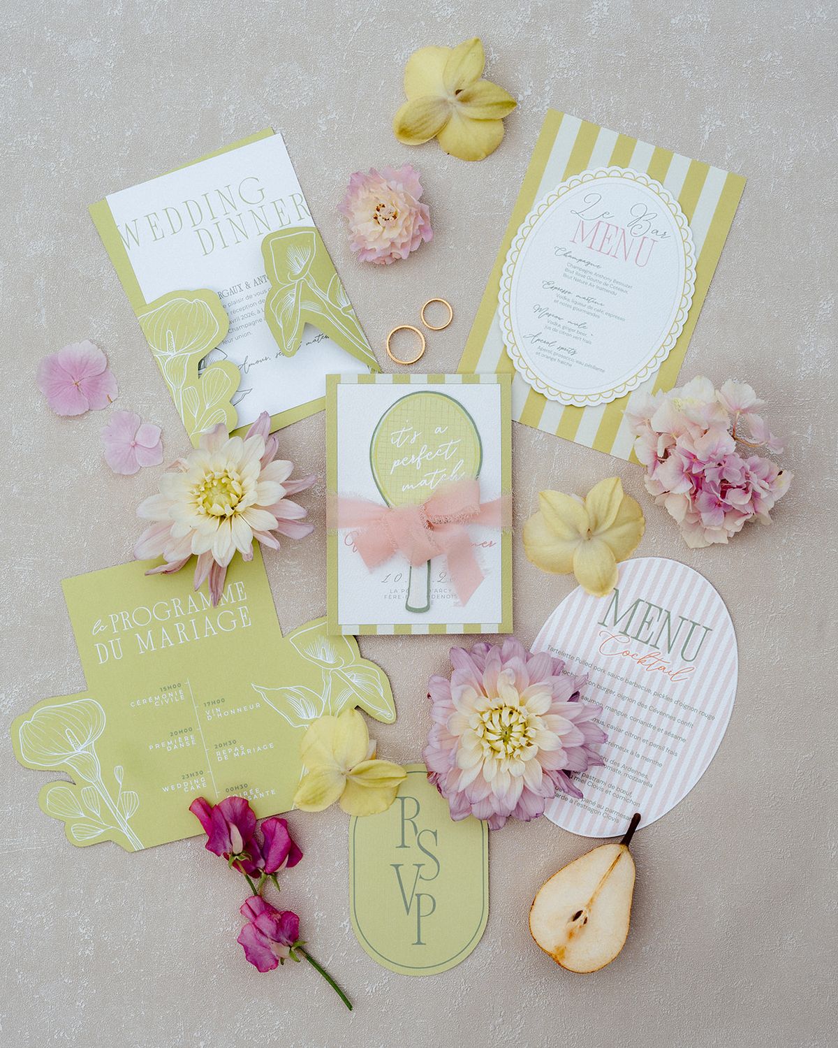 Wedding stationery in soft yellow and white stripes with dahlias, sweet peas and two gold rings