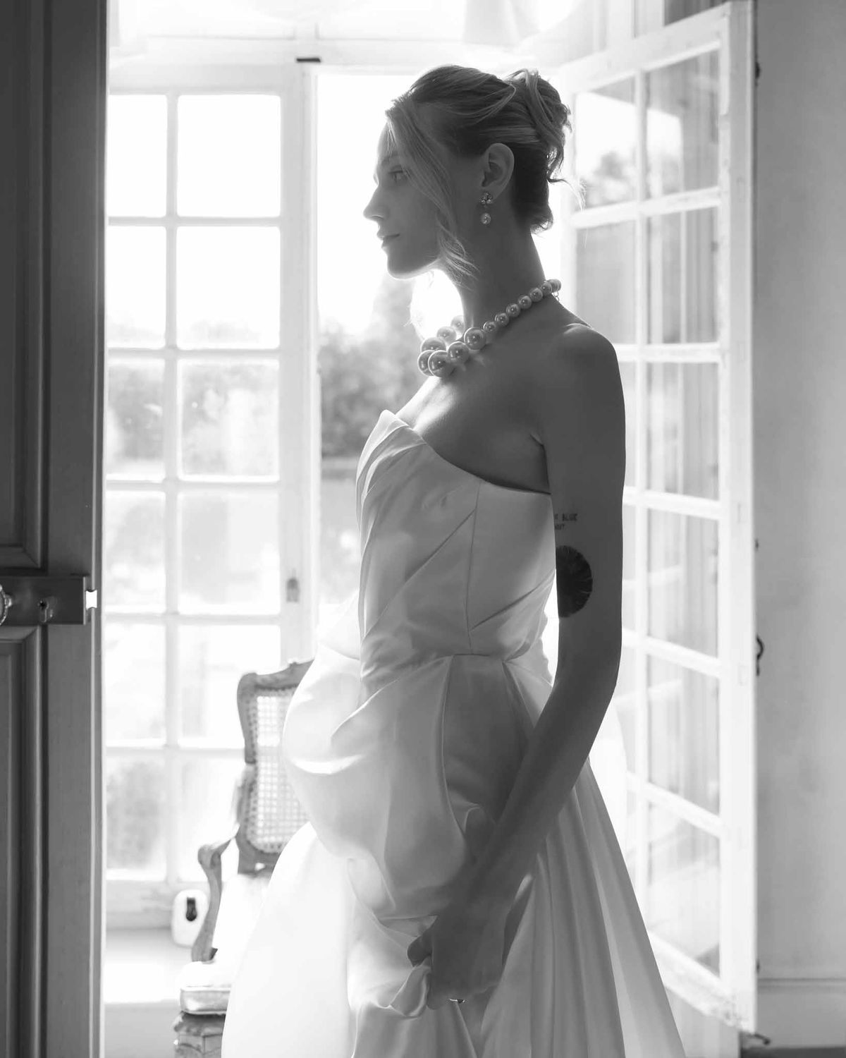 Bride in strapless gown wearing a large pearl necklace