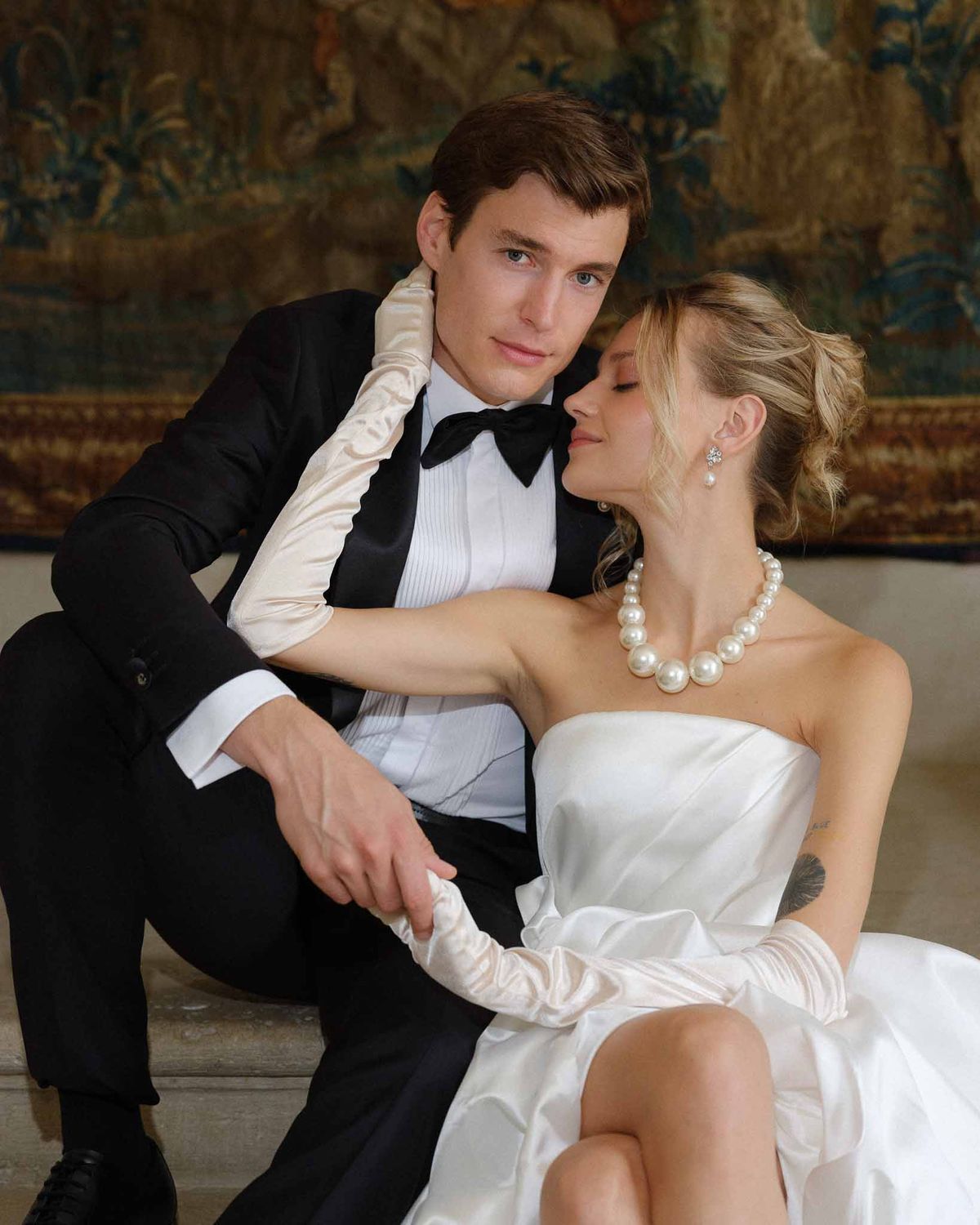 Bride cradling groom's face in an intimate close-up portrait