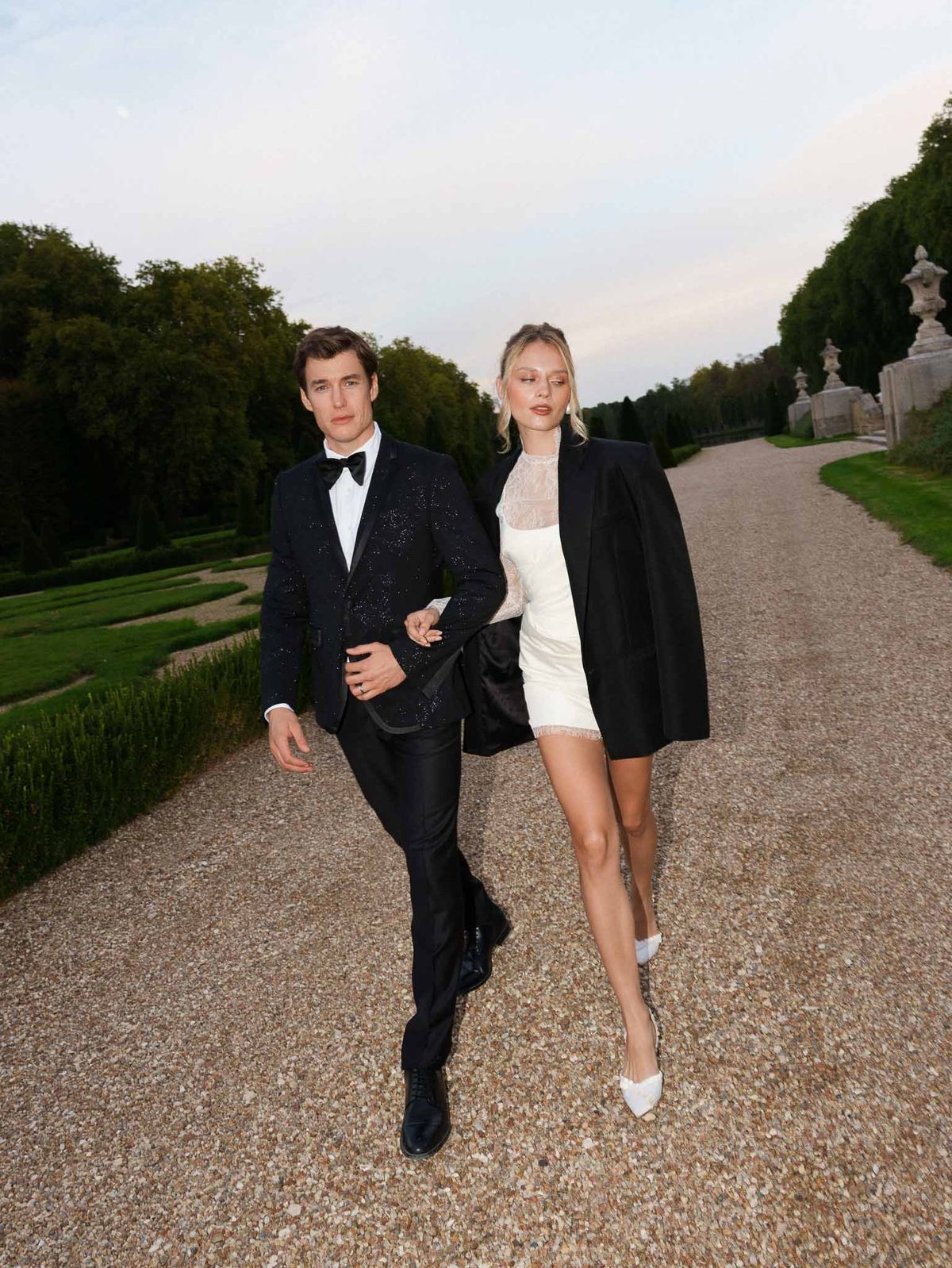 Couple walking in after-party evening attire at the reception