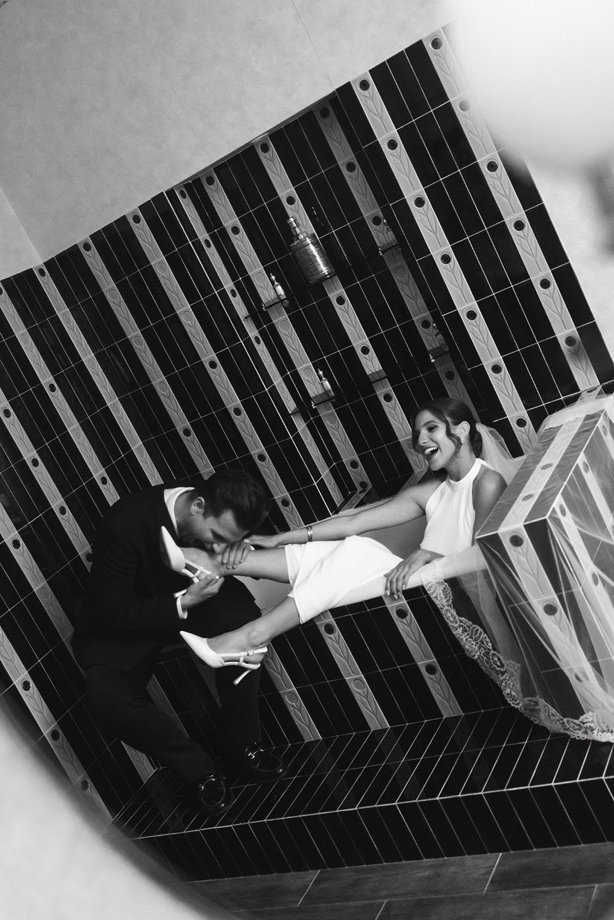 Black and white overhead portrait of a couple on a striped surface