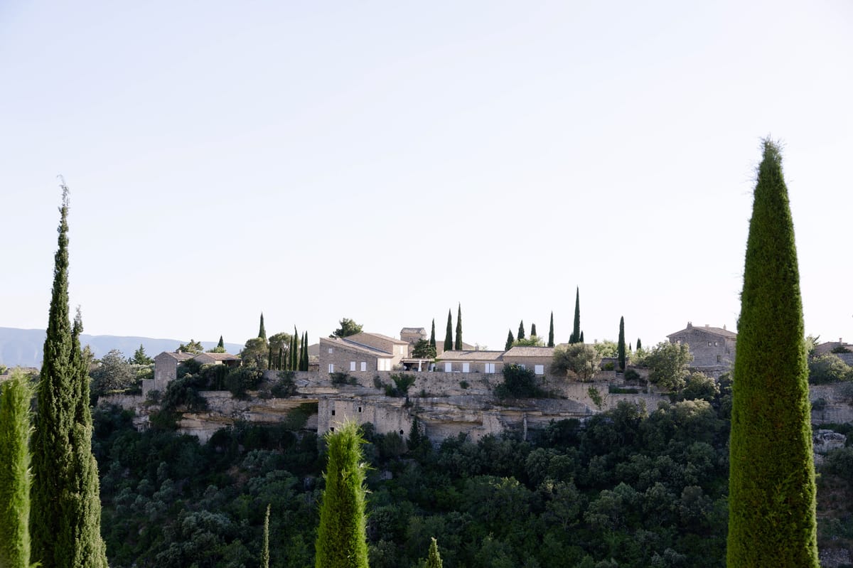 View of Gordes framed by cypress trees