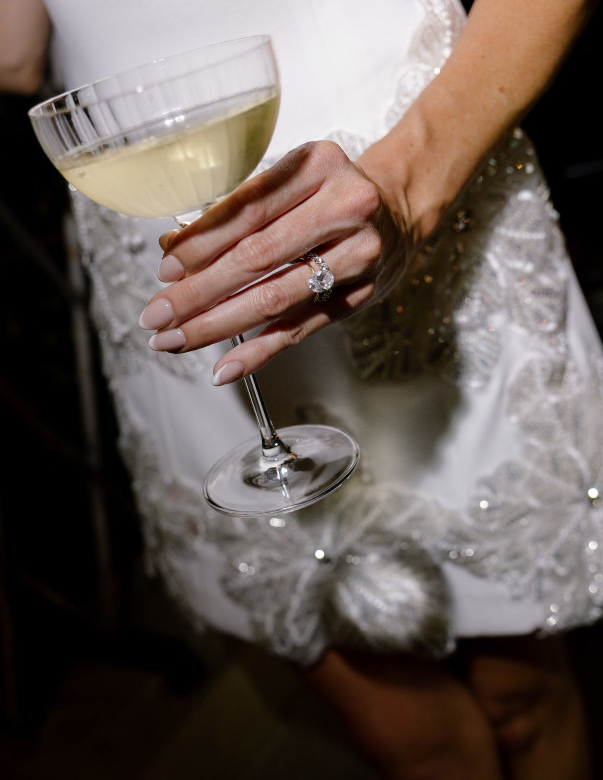 Detail of the bride's embellished short dress and a coupe