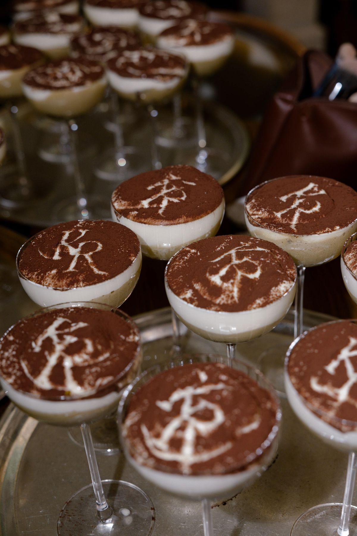 Individual tiramisù with initials dusted in cocoa