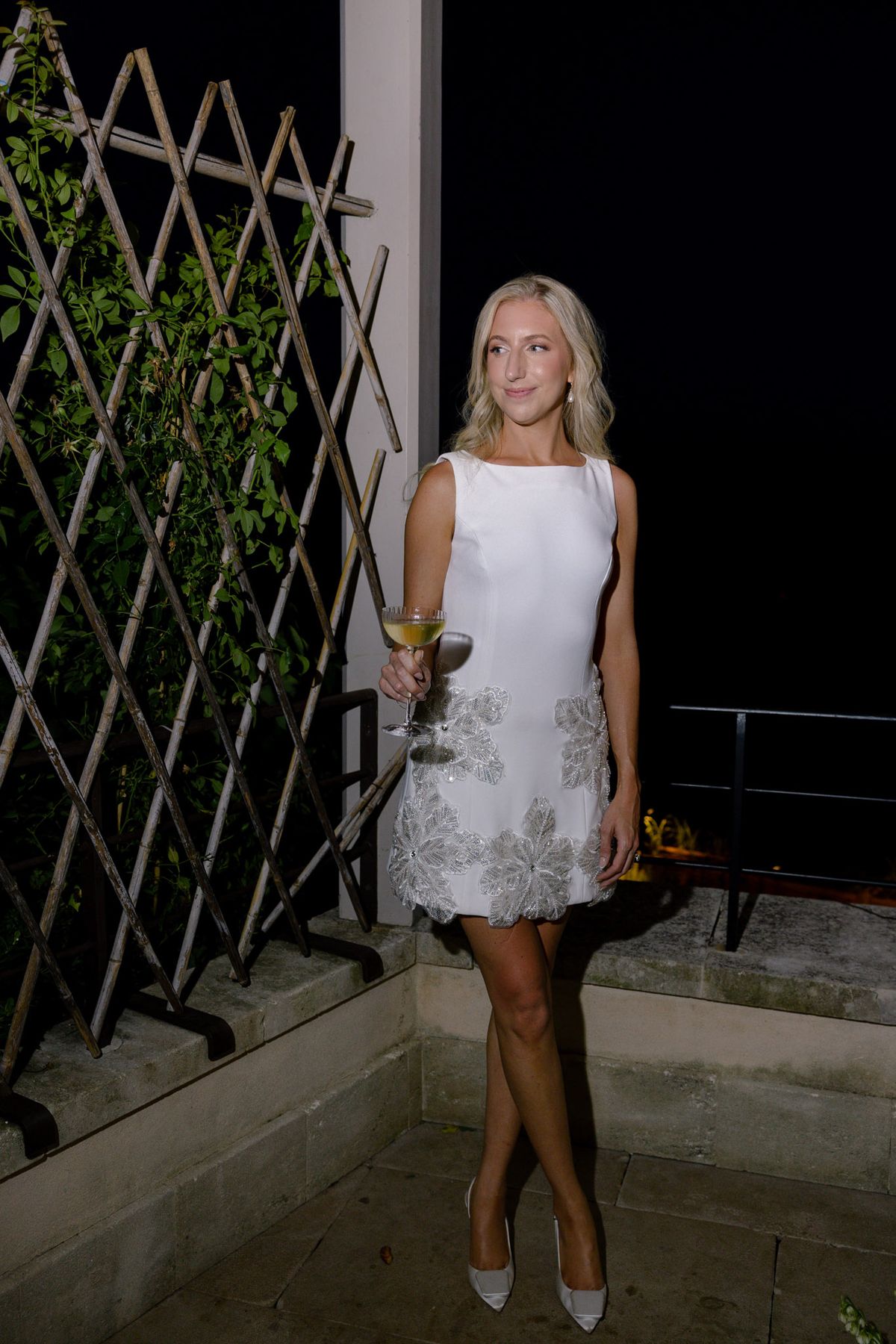 Bride in a short white dress at night