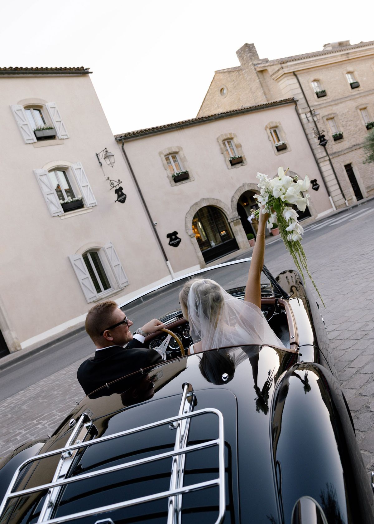 Couple in a convertible in the village square