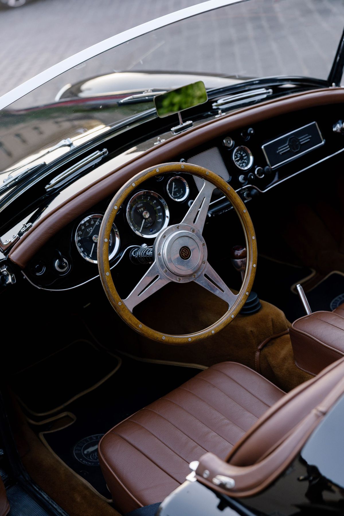 Leather seats and wooden steering wheel of a vintage convertible