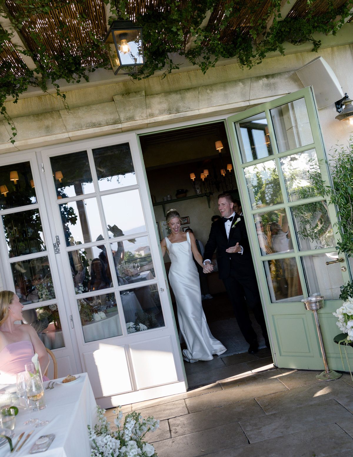 Kirstin and Ryan entering dinner through glazed doors