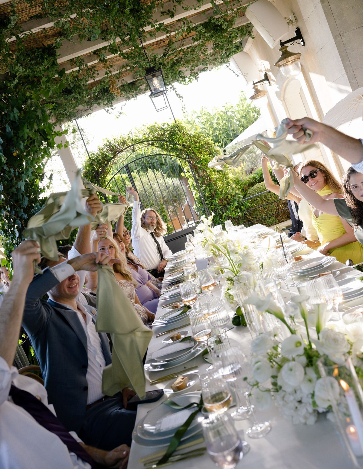Guests waving napkins at the dinner table
