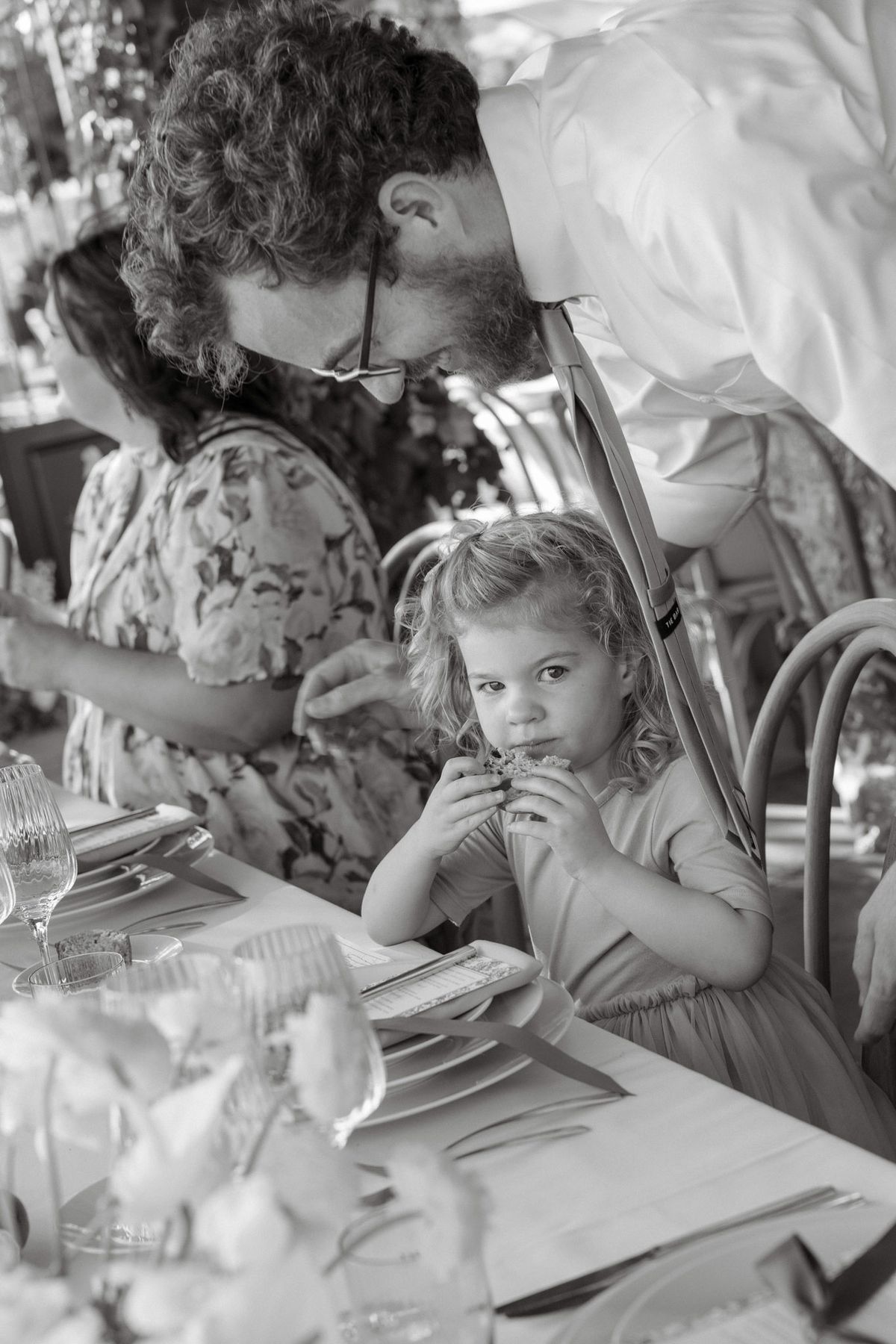 Black and white photo of a young guest at dinner