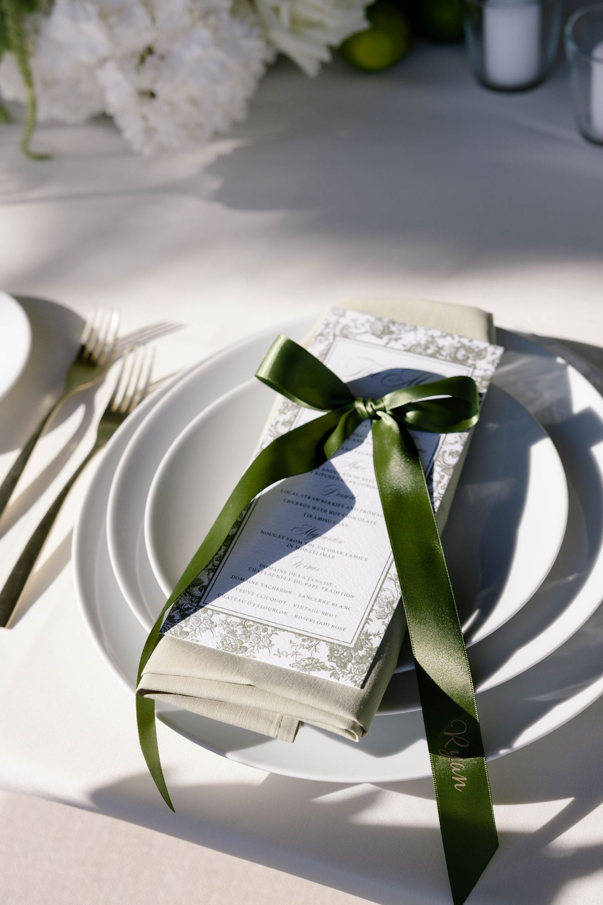Place setting with a menu tied in green ribbon