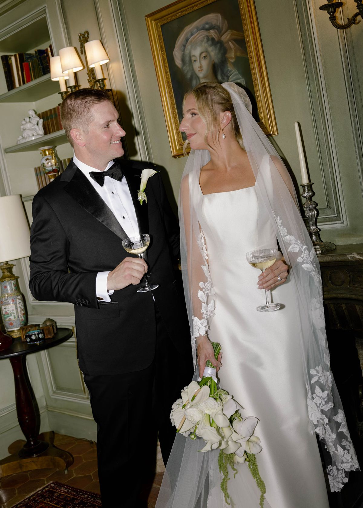 Kirstin and Ryan with champagne in a panelled library