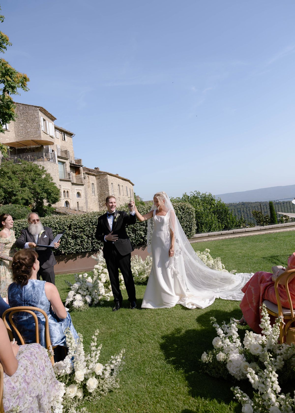 The bride's father officiating on the ceremony lawn