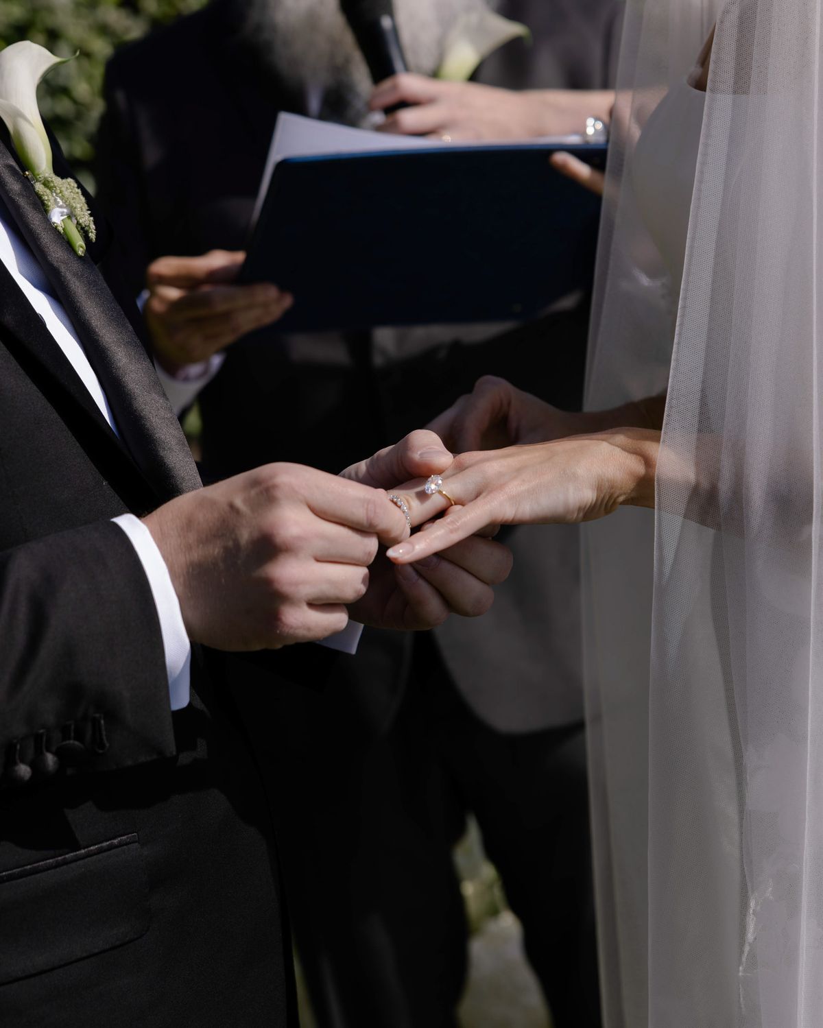 Groom placing the ring on the bride's finger