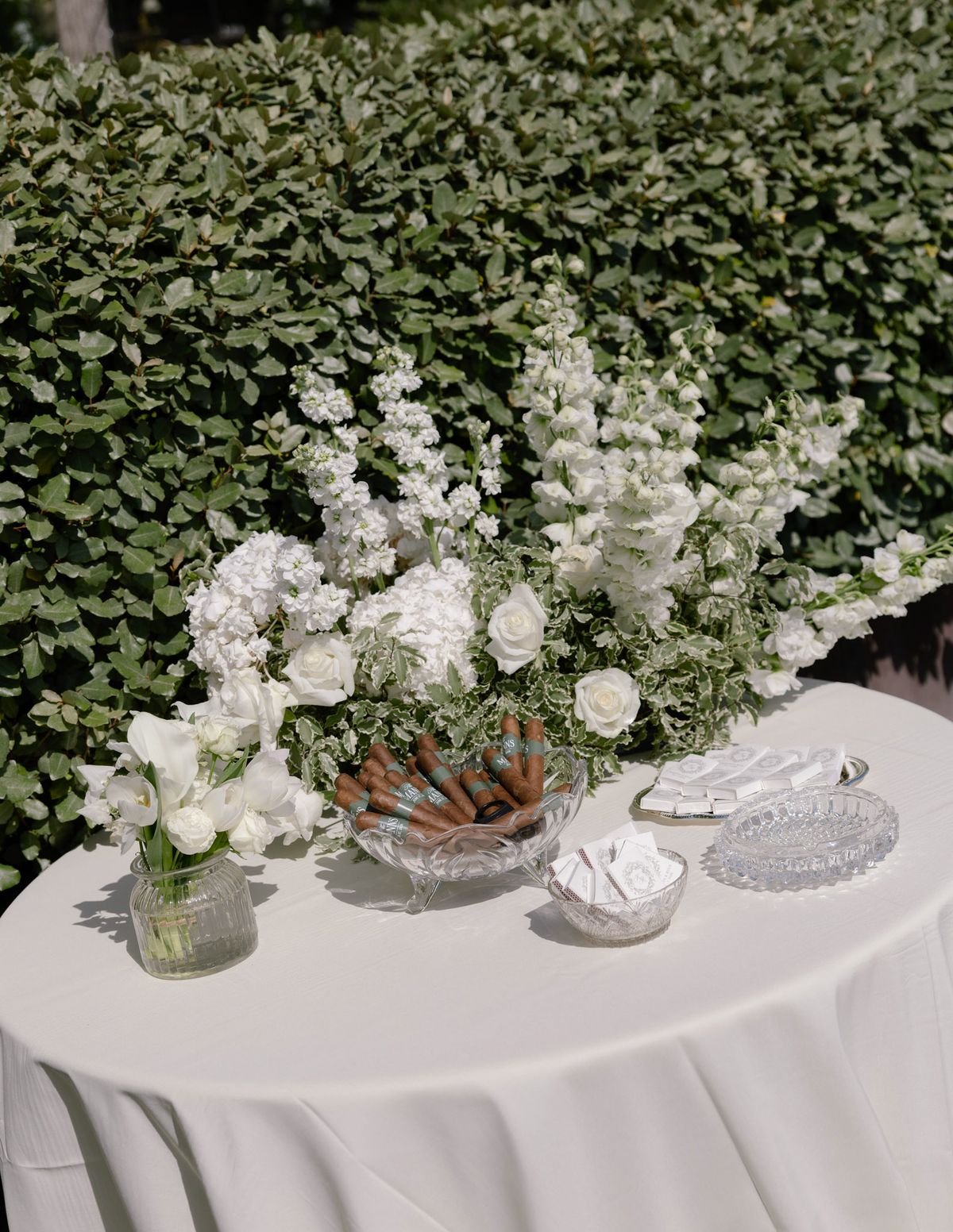 Round table with flowers and a tray on the lawn