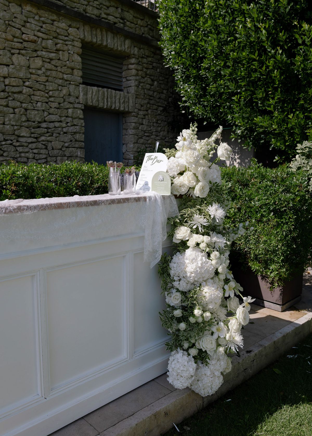 White bar dressed with a cascade of white flowers