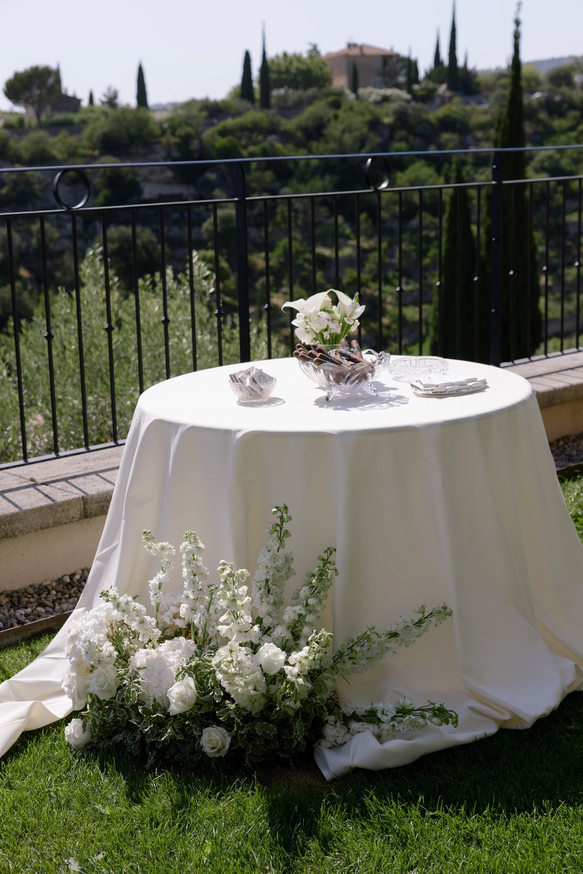 Round table with white flowers on a terrace overlooking the hills