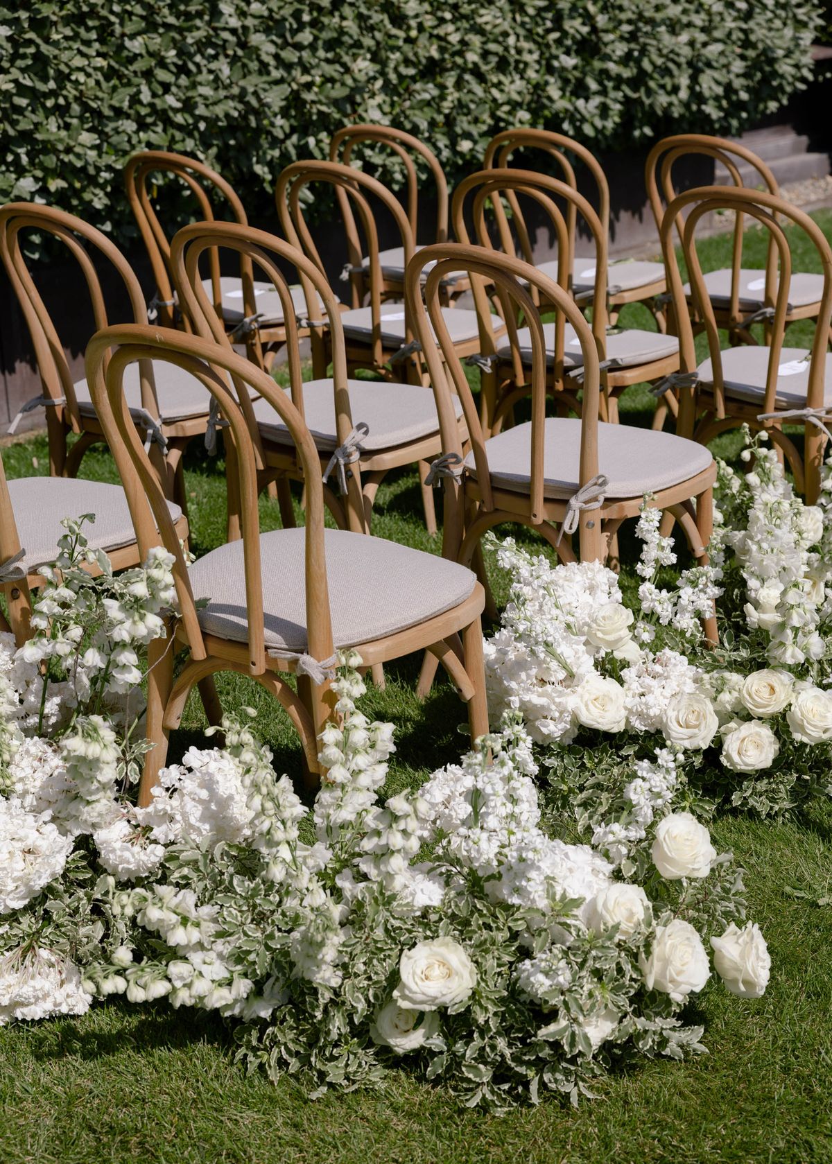 Rows of bentwood chairs edged with white flowers