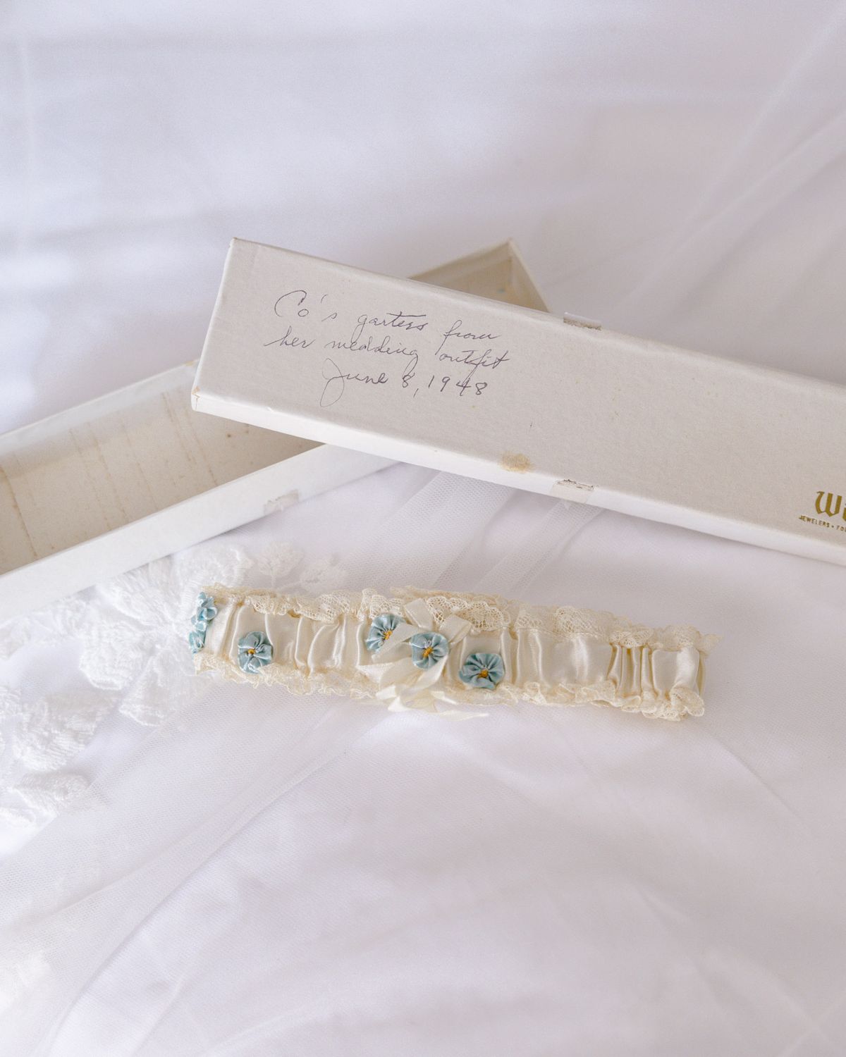 Bridal garter in its box with a handwritten note