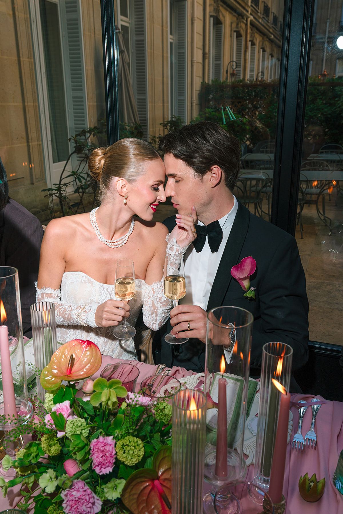Bride and groom sharing a champagne toast at the candlelit dinner table, Hôtel Alfred Sommier