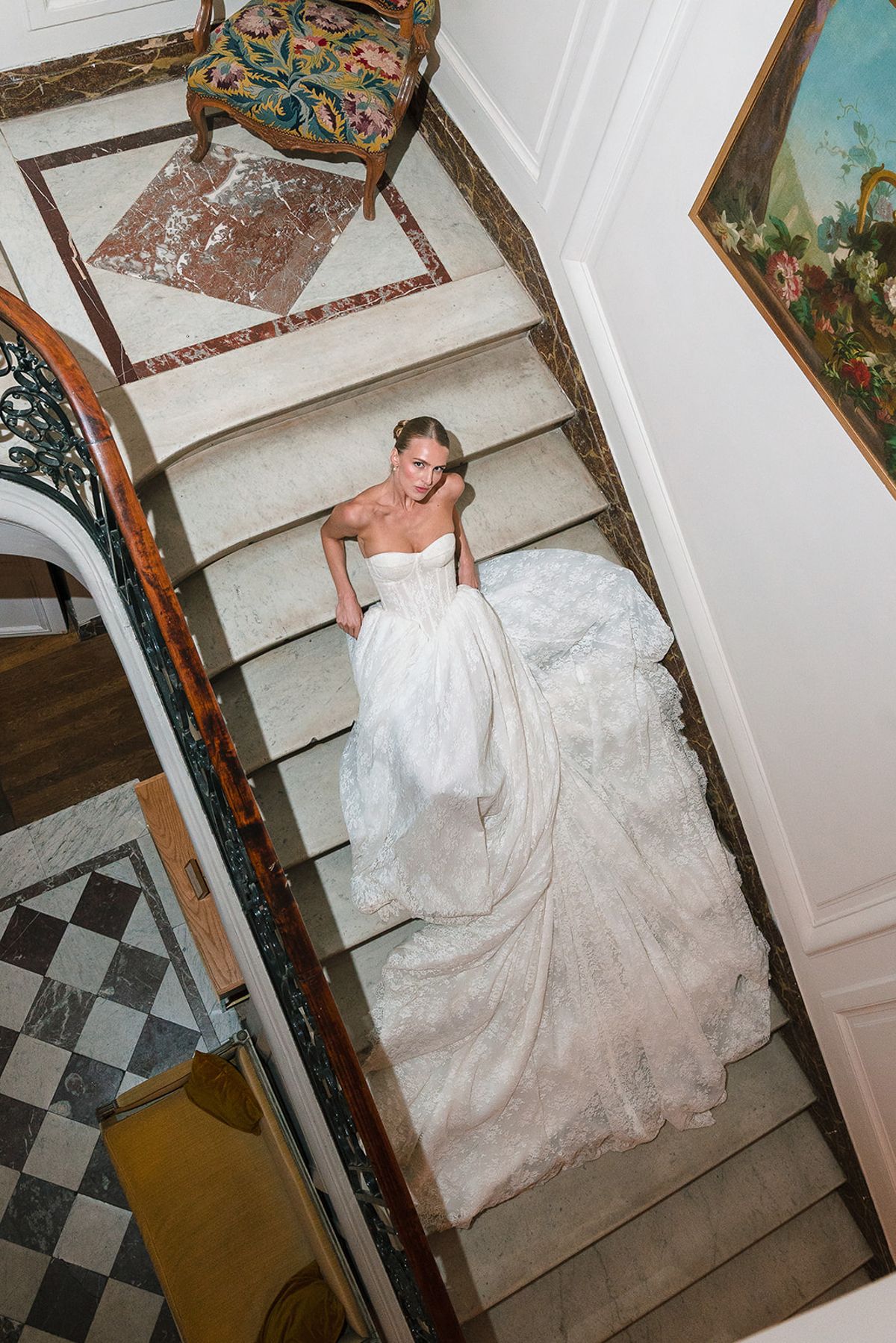 Bride descending the marble staircase with her train, seen from above at Hôtel Alfred Sommier