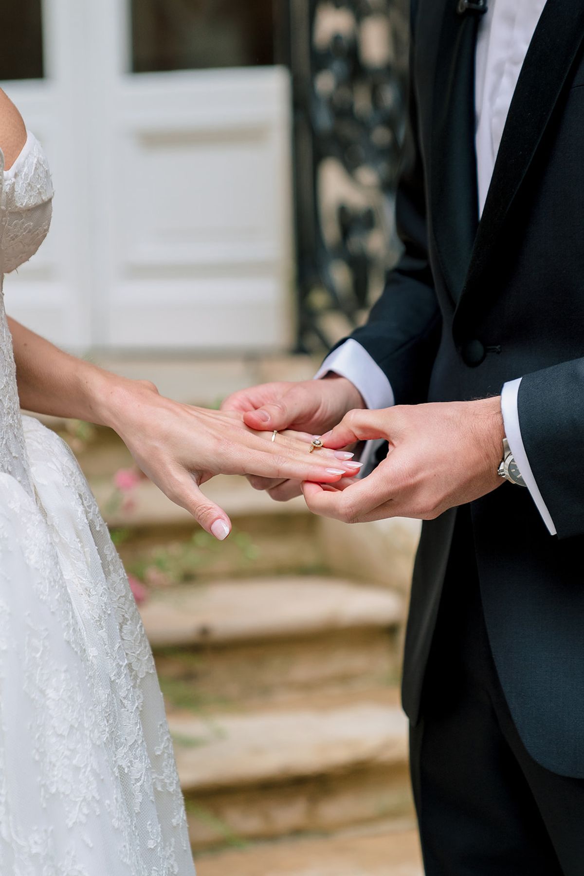 Groom placing the ring on the bride's finger during the ceremony