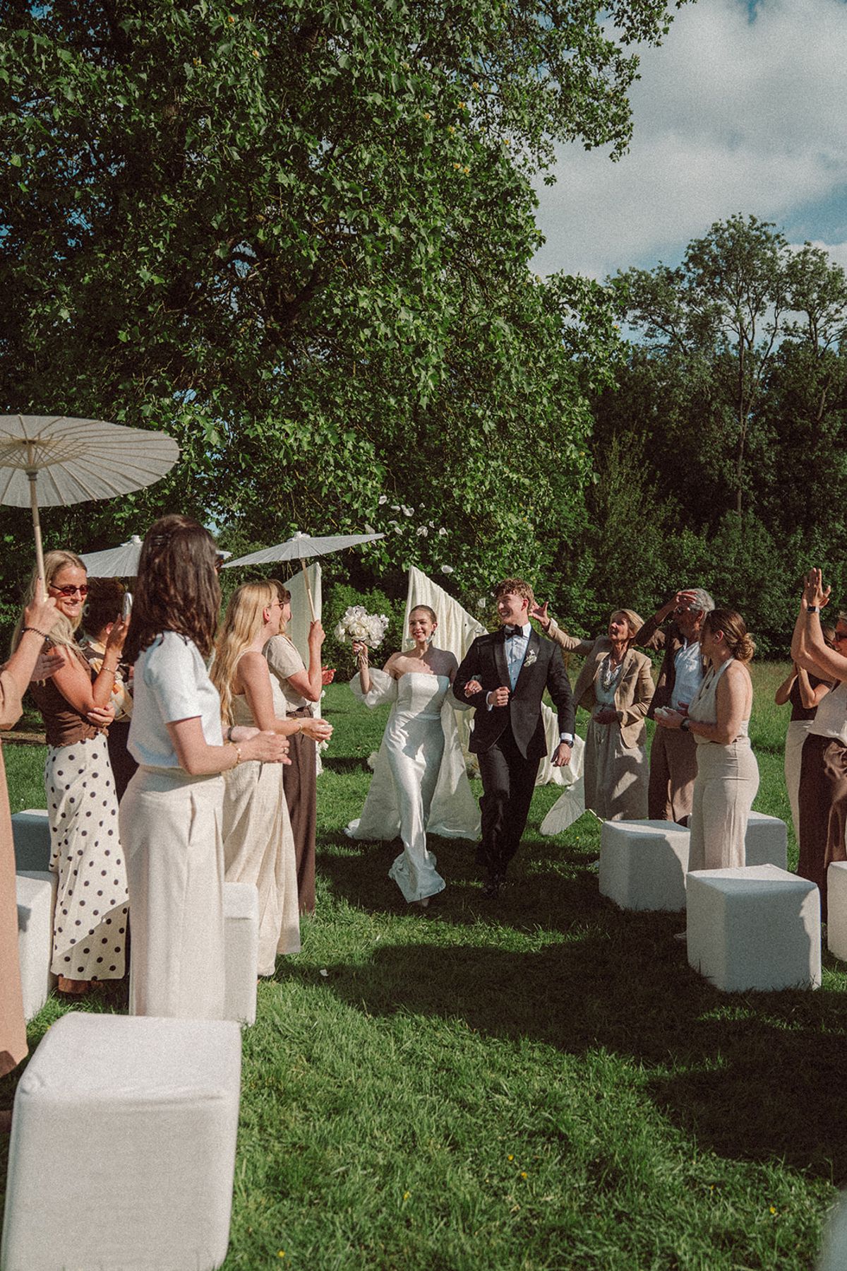 Guests watching the ceremony from a distance, wide shot